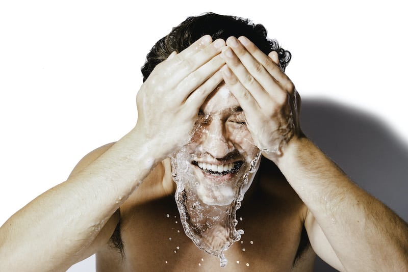 Handsome boy splashing face with water and skinB5 cleansing mousse to wash face