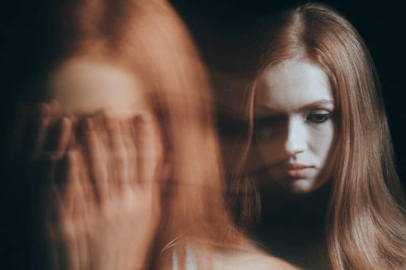 Stressed woman covering face